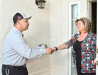 JS Pest Control technician treating home